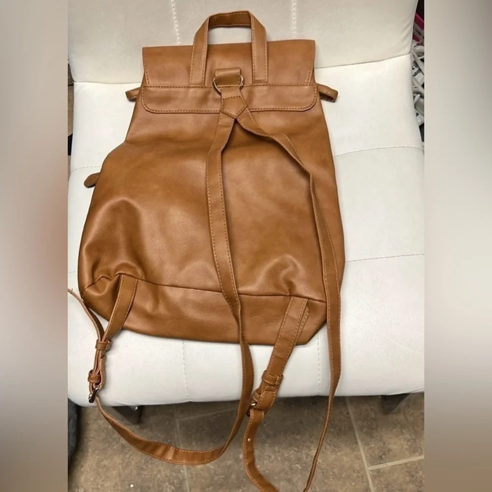 Brown backpack with zipper accented detailing on front, NWOT